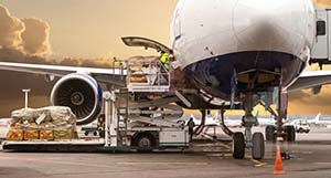 Airfreight containers being loaded onto a waiting aircraft